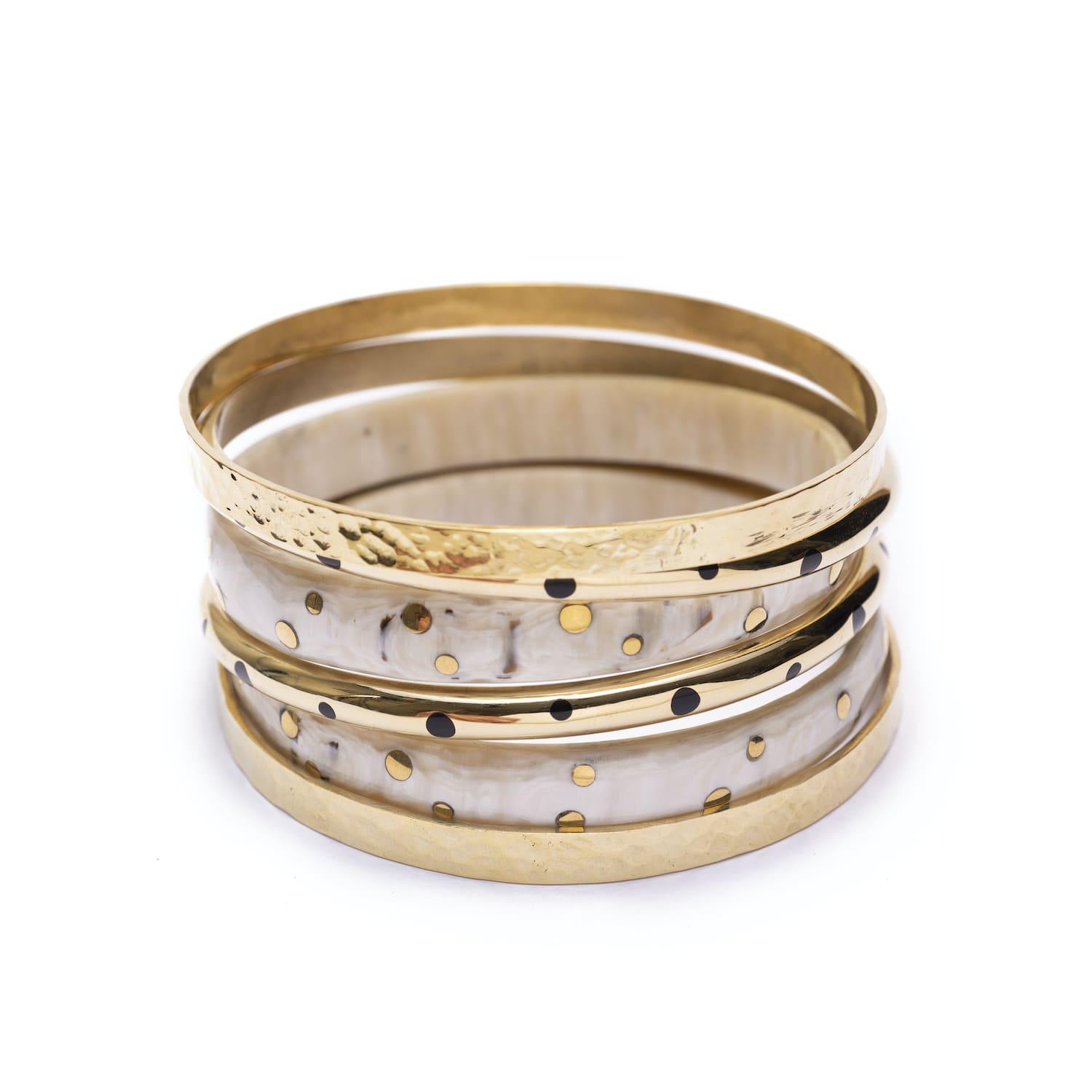 Stack of gold and white bracelets handmade from brass for women