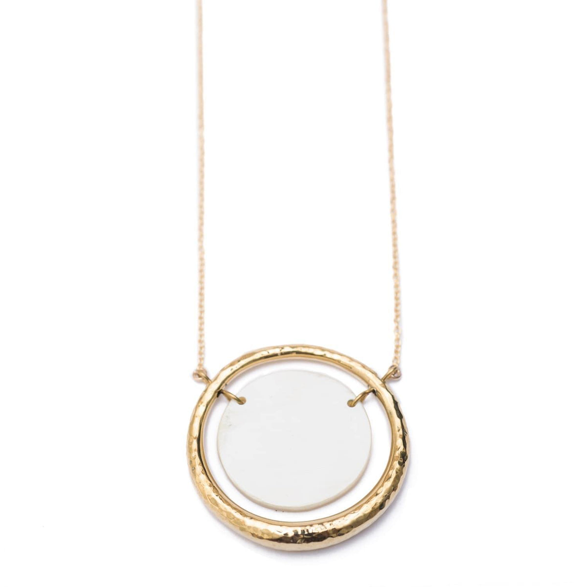 Elegant suspended gold plated hollow circular pendant with a white circle in the middle strung on a gold plated chain