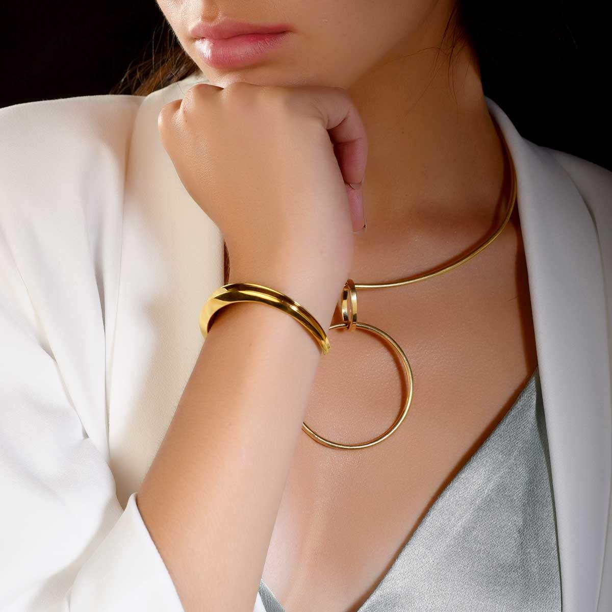 Model wearing narrow-to-wide 18k gold plated cuff bracelet - Tanzire