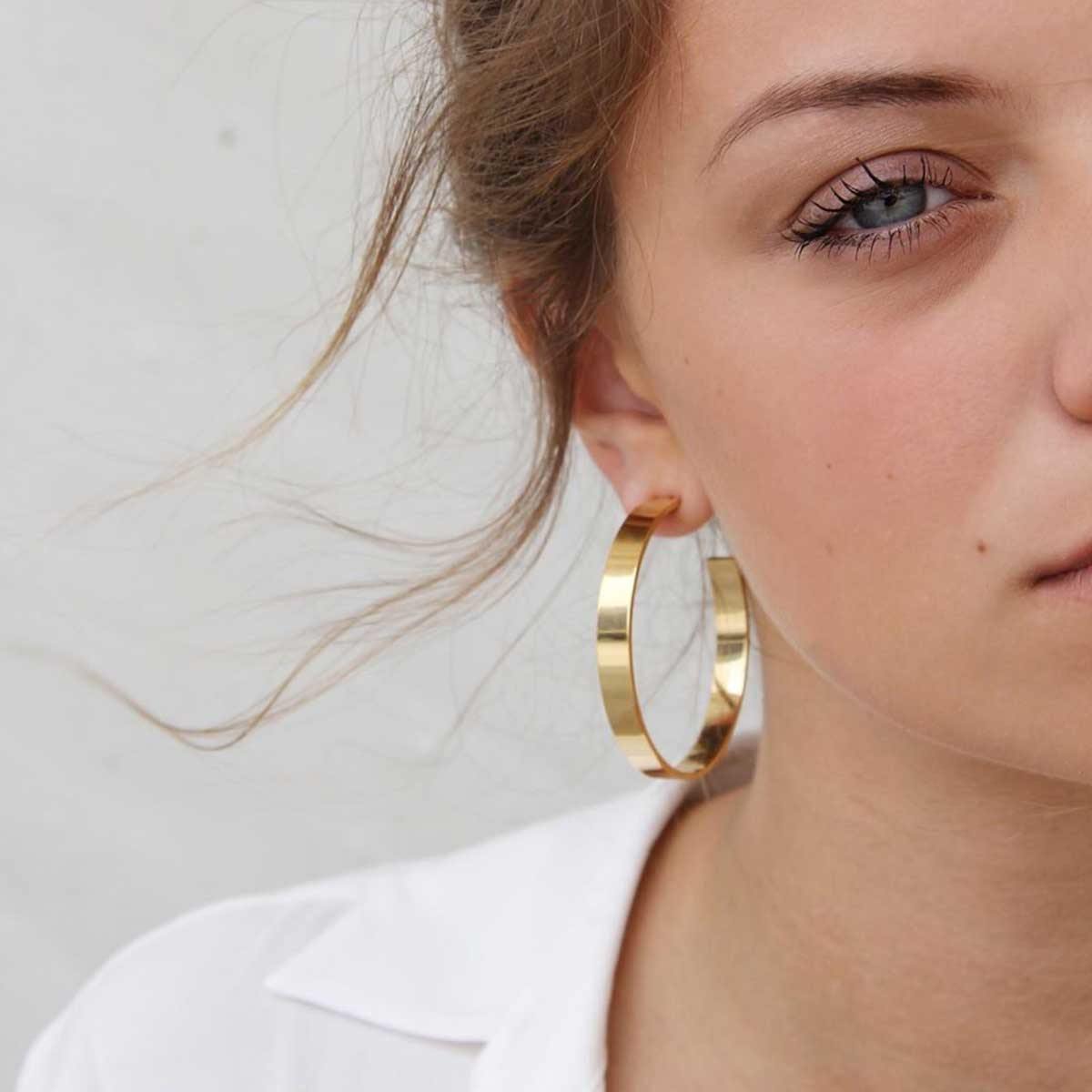 Model Wearing Contemporary Pair of 18k GoldPlated Hoop Earrings